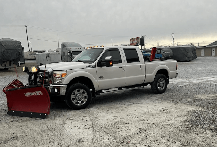 Image of truck with plow attached for snow removal service.